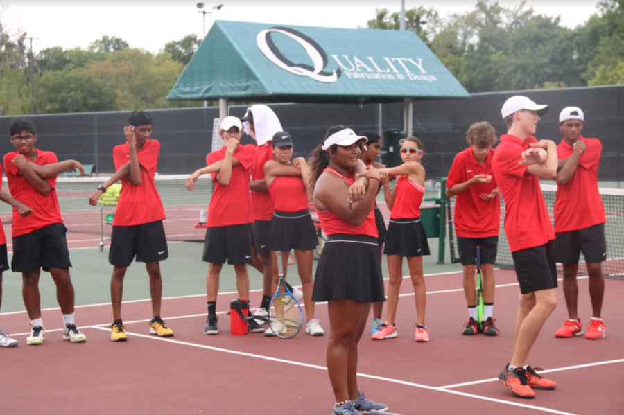 The Coppell tennis team stretches at the Coppell High School Tennis Center on Friday before the team’s match against Plano West. The Wolves defeated Coppell, 15-4.