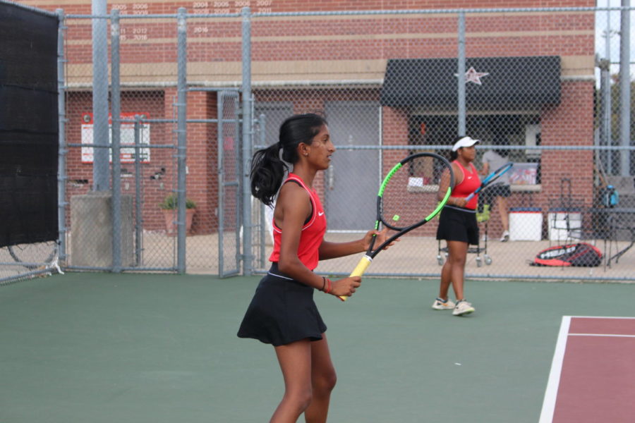 Coppell seniors Aishwarya Kannan and Ruchika Khowala wait to return a shot against Tyler Lee at the Coppell High School Tennis Center on Satuday. The Coppell tennis team defeated Lee, 17-2. 