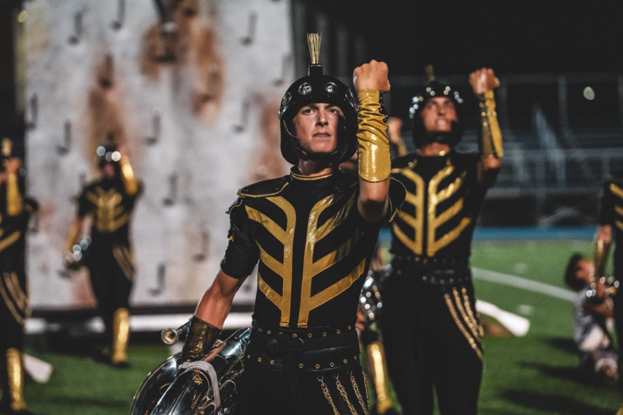 New Tech senior Mason Clark poses for the Boston Crusaders on Aug. 1 in Lawrence, Mass. Clark’s outfit is a Crusader, a medieval fighter. Clark wields his tuba in the left hand and the right up in the air. Photo courtesy Mason Clark