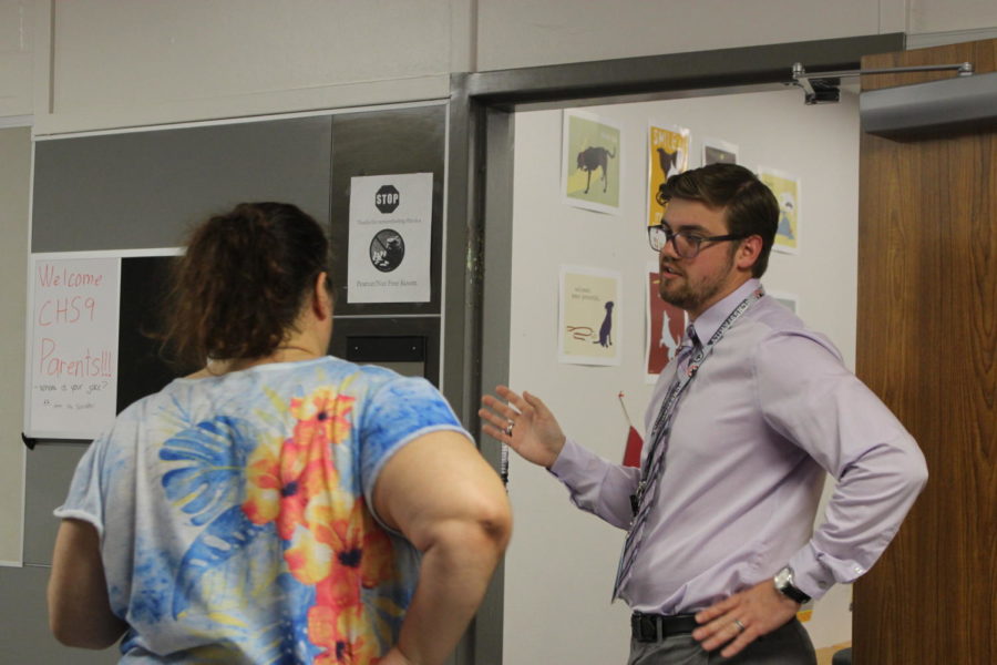 CHS9 English teacher Christopher Arney talks to a parent at Open House on Sept. 3. Arney is new to the campus for the 2019-20 school year. 