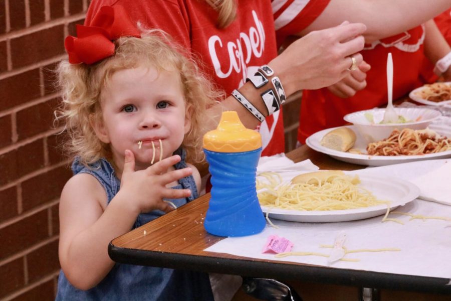 Ruby Rives of Coppell enjoys her spaghetti dinner with her family. The Lariettes had their 30th annual spaghetti dinner in the commons on Sept. 6 before the first home football game.