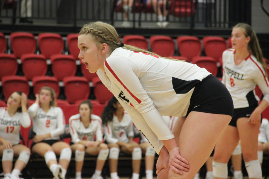 Coppell freshman Reagan Engler awaits a serve during the match against Arlington Martin on Aug. 27 in the CHS Arena. Engler was coached by her mother, Coppell Middle School North coach Abby Martens in seventh and eighth grade and now plays for the Coppell varsity team. 