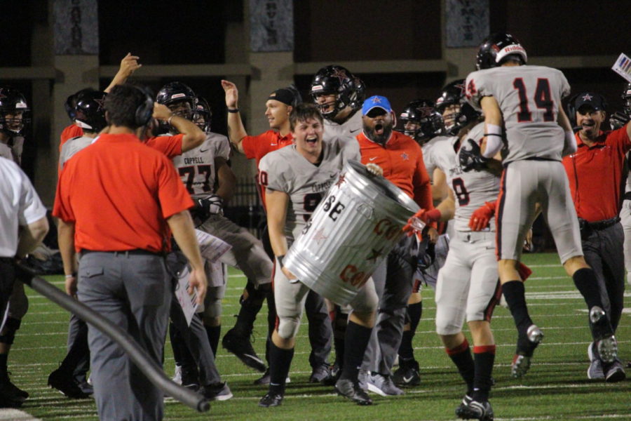 The Coppell varsity team and coaches celebrate an interception on Friday at Joy and Ralph Ellis Stadium in Irving. Coppell defeated MacArthur, 42-6. 
