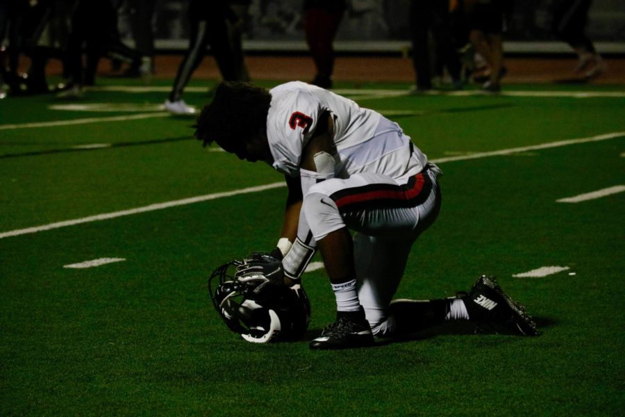Coppell senior running back Cam Williams kneels after the Cowboys loss to Marcus. The Cowboys held the lead through the first half before losing in overtime, 15-7, on Friday at Marauder Stadium in Flower Mound.