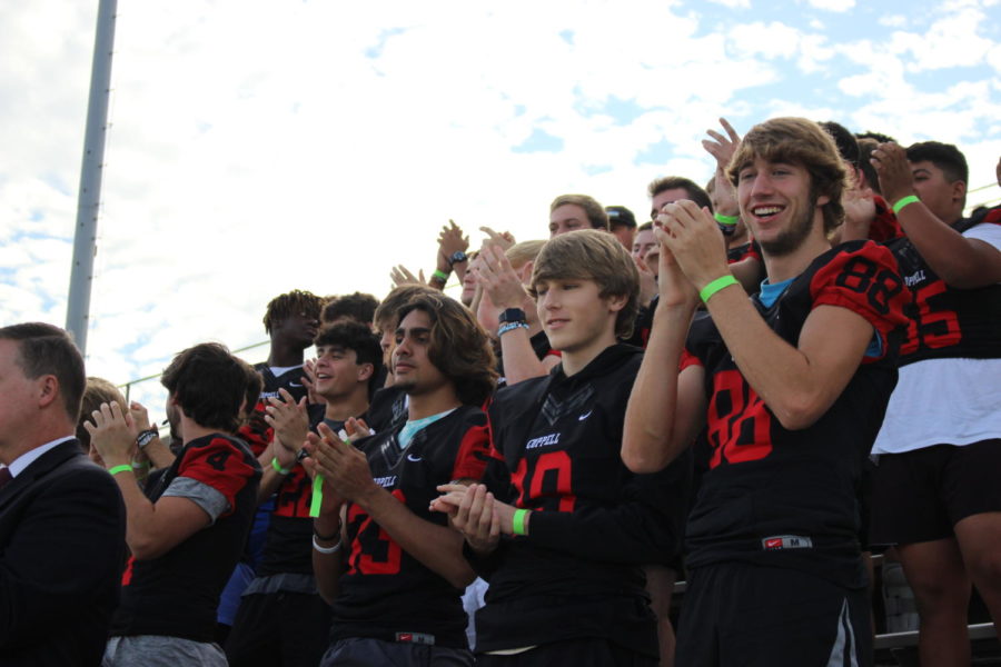 Coppell High School’s varsity football team cheers on the varsity marching band at the UIL Region 31 Marching Contest at Standridge Stadium on Tuesday. The Coppell varsity marching band scored a 1, the highest possible score, at the contest. 