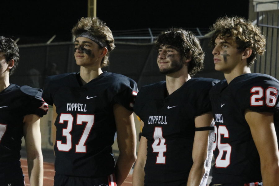 Coppell juniors kicker Skyler Stricker (No. 37) and defensive back Zach Stricker (No. 4) watch with senior kicker Andrew Espindola (No. 26) from the sidelines during Coppell’s first home district game against Hebron on Oct. 5. The brothers are both deeply involved in their respective sports but also make time for student ministries and family.