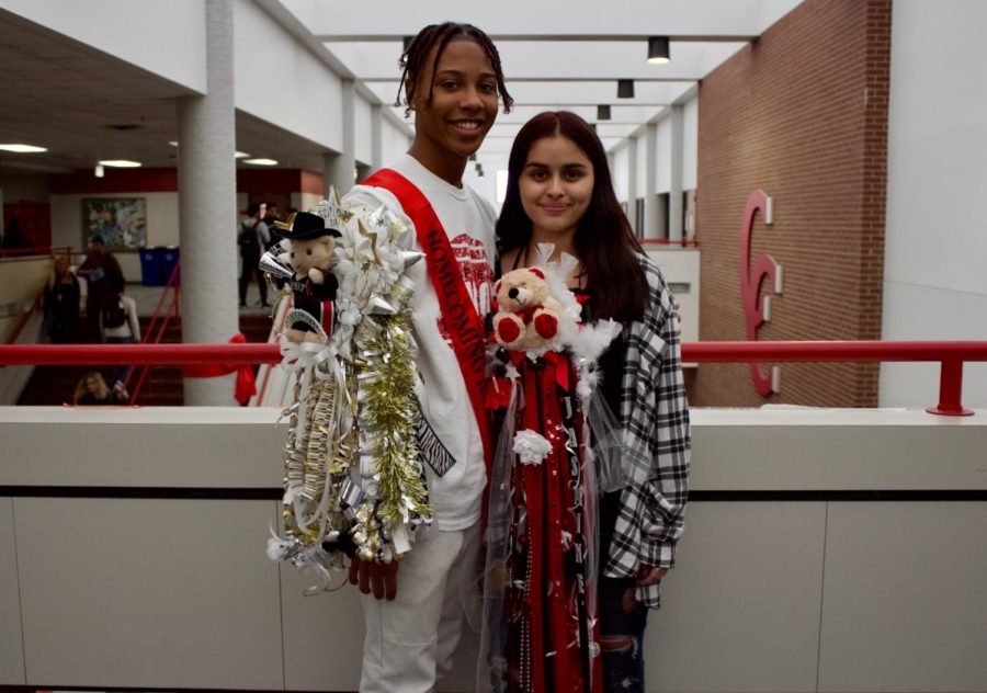 Coppell+High+School+senior+Zack+Findley+and+sophomore+Jasmine+Gomez+wear+their+homecoming+mum+and+garter+during+passing+period+on+Friday+on+the+senior+bridge.+The+homecoming+dance+will+take+place+on+Oct.+26+at+the+Irving+Convention+Center+from+8+p.m.+to+12+a.m.