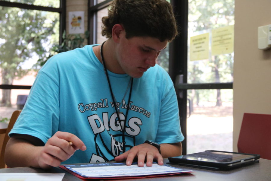 Coppell+High+School+sophomore+student+council+President+Samuel+Taylor+marks+important+StuCo+events+in+his+calendar+after+school+on+Sept.+25+in+the+CHS+Library.+Taylor+is+excited+to+use+his+leadership+position+in+StuCo+to+achieve+his+goals+for+the+program.+