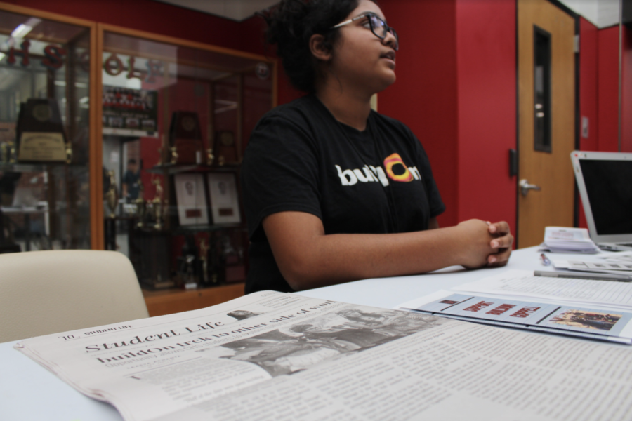 Senior buildOn co-founder Ananya Pagadala displays the article written about buildOn in the October issue of The Sidekick on her table at the club expo during C lunch on Friday. Coppell High School students were given the opportunity to promote their clubs to students to gain membership for the school year at the expo on Friday. 