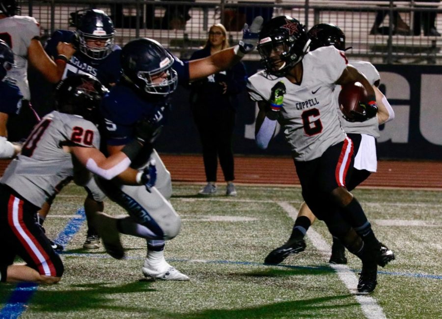 Coppell junior running back Jason Ngwu slips past Flower Mound defenders at Neal E. Wilson Stadium on Nov. 1. The Cowboys face Irving Nimitz tomorrow at 7 p.m. at Buddy Echols Field for their last game of the season.