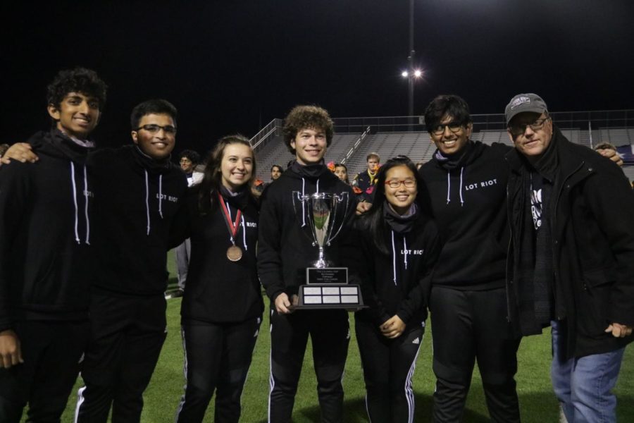 The Coppell High School drumline team takes a picture with the Cardwell Cup on Nov. 9 at Marcus Marauder Stadium. The team receives first rank with a 96.88 rating in the Standstill I Silver Prelim part, Best Snare Line, Best Front Ensemble, Most Creative Drumline Show and The Cardwell Cup for Best Percussion Performance at Lone Star Classic 2019. 
