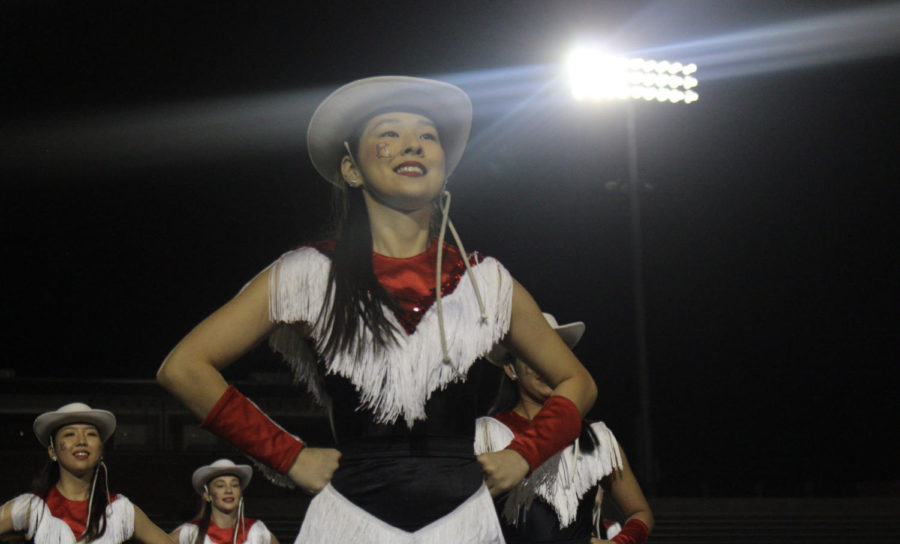 Coppell High School senior Lariette Irene Son walks off the field after a performance during the homecoming pep rally at Buddy Echols Stadium on Oct. 23. The pep rally followed the parade, driving school spirit for homecoming week.