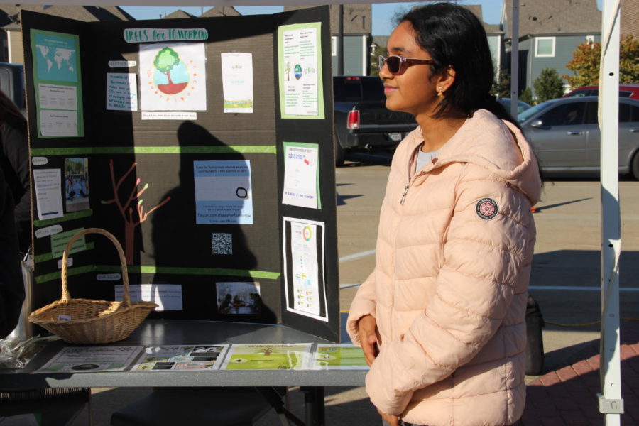 Coppell High School junior Swetha Tandri promotes her nonprofit organization Trees for Tomorrow at the Coppell Farmers Market on Nov. 16. Tandri promotes the use Ecosia over Google since it is a search engine that plants trees with a portion of the profits from advertisements.