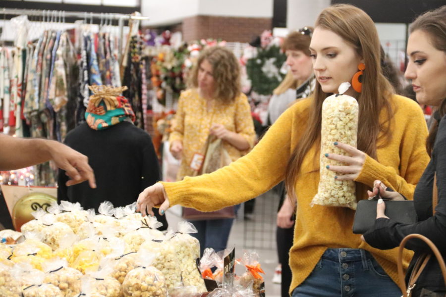 Shoppers choose various popcorn flavors at Nikki’s Popcorn booth in the lower level of the cafeteria during Coppell High School’s Holiday House on Sunday. Holiday House is an annual benefit for Project Graduation and provides an opportunity to buy homemade Christmas gifts from local sellers. 