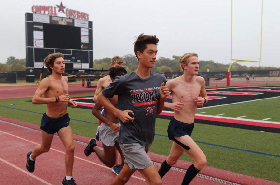 Coppell junior Evan Caswell warms up with his teammates at cross country practice on Tuesday morning on the Buddy Echols Field track. Caswell holds school records in two cross country events and is chasing his third record in a track event.