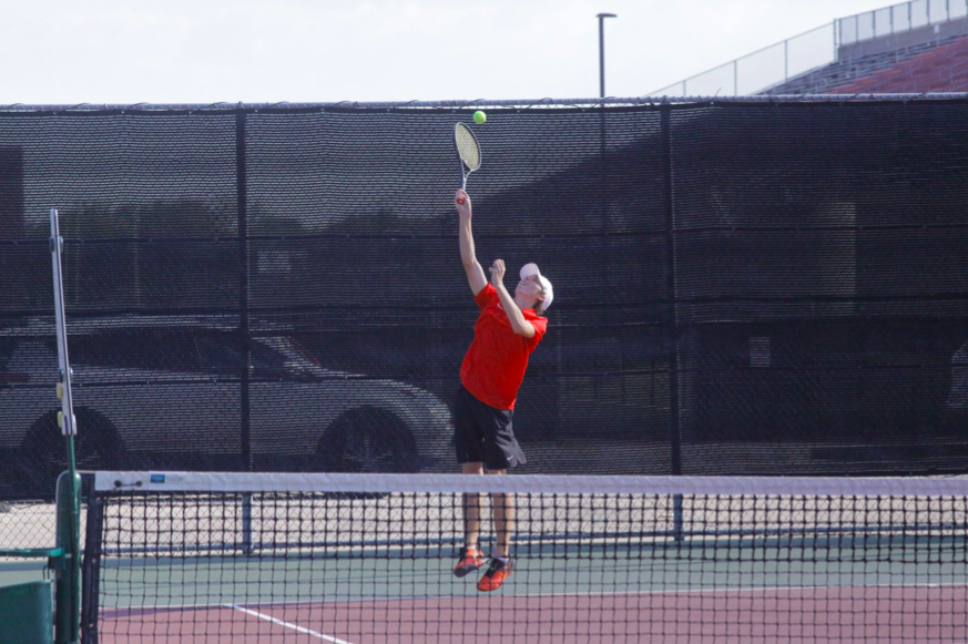 Coppell senior varsity tennis player Clark Parlier hits the tennis ball on Sept. 7 at the Coppell High School Tennis Center. Parlier is also a member of the Coppell varsity hockey team and balances both sports with his schoolwork.
