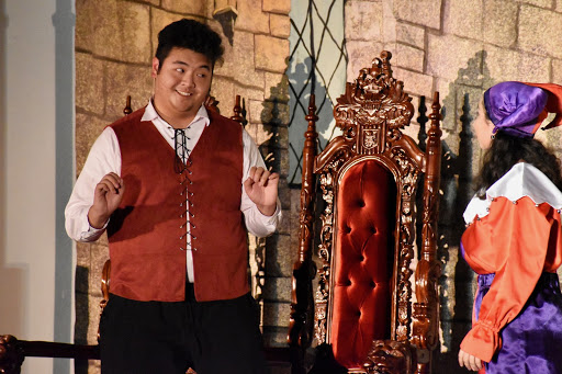 Coppell High School senior Max Madlambayan acts out a scene with junior Annelise Holguin during the choir’s annual Madrigal Feast titled “The Perfect Lie” in the CHS Commons on Friday. Madlambayan shows his love for the fine arts through the CHS theater and choir departments.