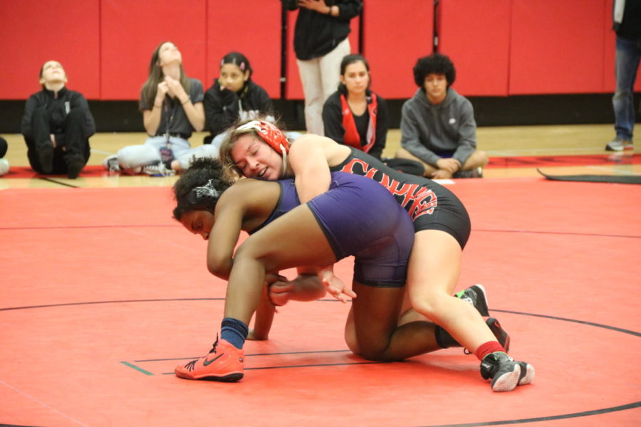Coppell senior team captain Brooke Massaviol wrestles in top position against Frisco Independence junior Sariah Ferguson at the Knockout Sportswear Cowgirl Classic on Friday in the CHS Arena. The Cowgirls place first in the tournament with a team score of 101.