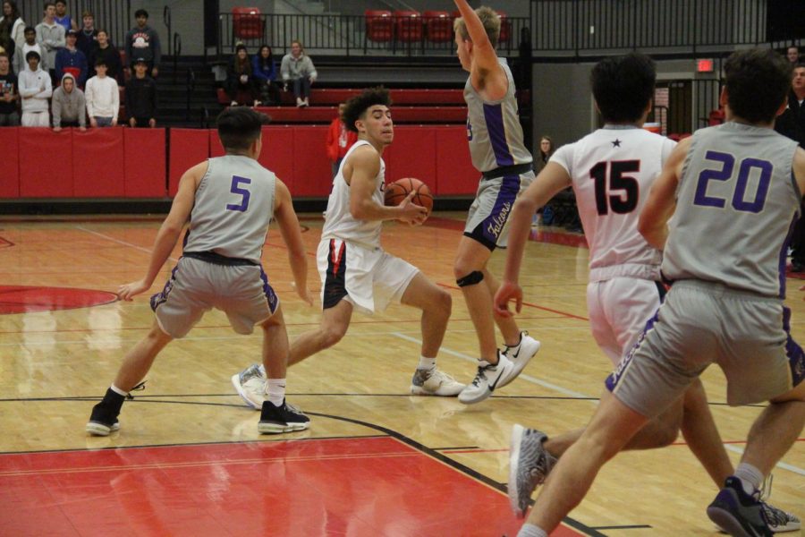 Coppell+senior+guard+Brandon+Taylor+looks+to+pass+in+the+CHS+Arena+on+Tuesday+against+Timber+Creek.+Coppell+defeated+the+Falcons%2C+55-47.