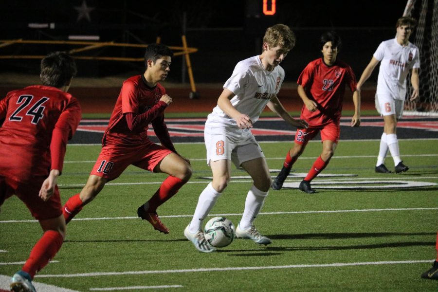 Coppell senior midfielder Caleb Razo attempts to steal from Frisco Wakeland’s Jak Kieth during the scrimmage on Thursday at Buddy Echols Field. The Cowboys defeated the Wolverines, 4-3, on a free kick. 