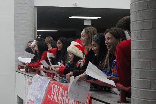 Coppell High School Red Jackets sing Christmas carols on the senior bridge during the passing period before seventh period. Red Jackets Christmas carols are an annual campus tradition where Red Jackets sing for the school to celebrate the holidays.