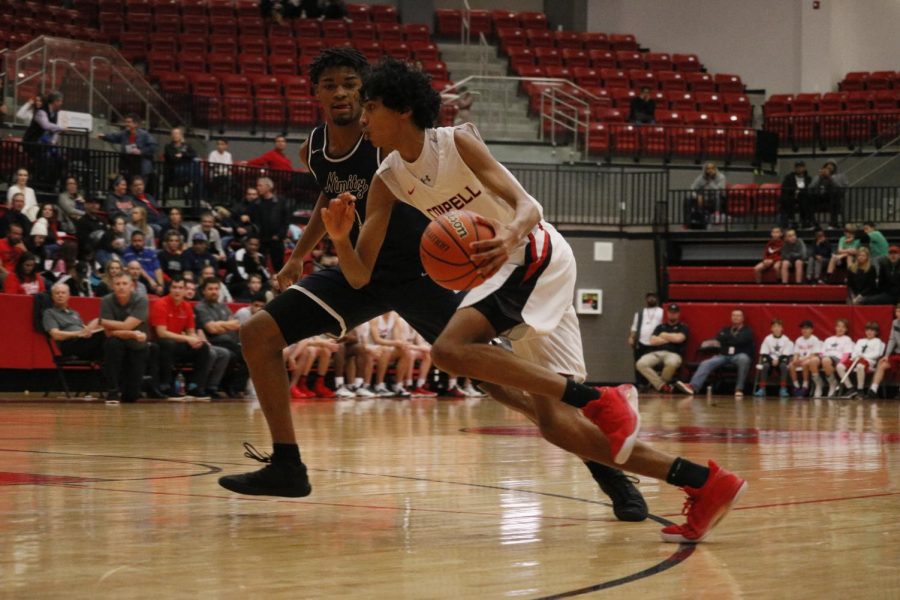 Coppell sophomore guard Ryan Agarwal shields the ball and attempts to make a play during the Cowboy’s game against Irving Nimitz on Friday in the CHS Arena. The Vikings fell short to the Cowboys, 61-35, in their District 6-6A game. Photo by Sydney Rowe. 

