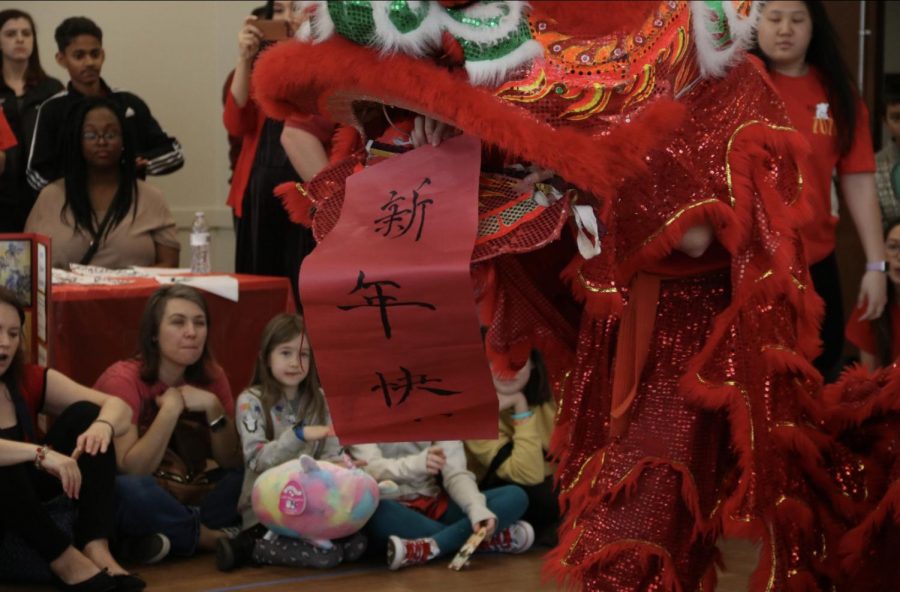 The Lion dance, performed by Coppell High School junior Kevin Ly and senior Kaitlyn Chieh attracts many attendees during the Chinese New Year event on Saturday afternoon at the Cozby Library and Community Commons. Attendees had an opportunity to understand more about the Chinese New Year and experienced all the cultural activities by themselves.