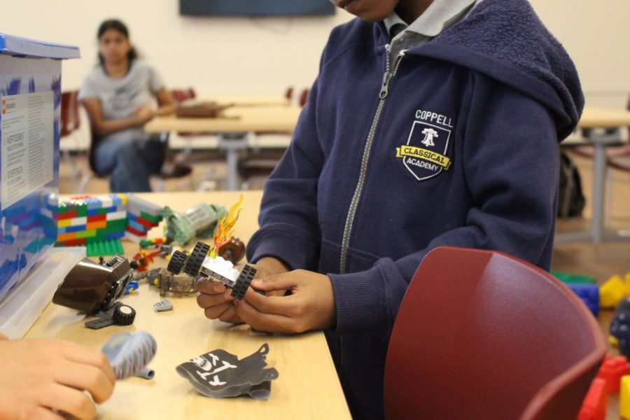 Coppell Classical Academy third grader builds a LEGO car as his mother watches. The Cozby Library and Community Commons has a weekly STEAM (science, technology, engineering, art and math) club for K-5 children that inspires creativity from an early age.