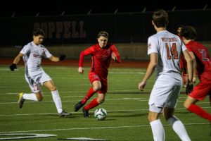 Coppell freshman center midfielder Nicolas Radicic passes during the scrimmage against Frisco Wakeland on Dec. 12 at Buddy Echols Field. After playing soccer for 14 years, Radicic is one of two freshmen on the varsity team.