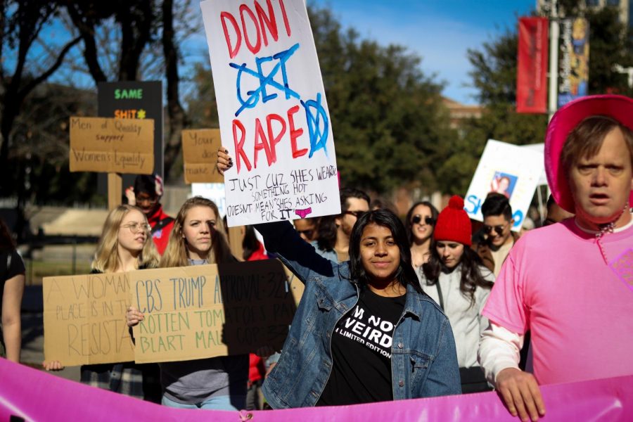 Coppell High School senior Roma Mazumdar holds a sign protesting the placing of blame on rape victims at the 2020 Dallas Women’s March on Jan. 19. Although the portrayal of sexual assault in media has improved through the past decade, The Sidekick executive news and enterprise editor Pramika Kadari thinks writers and filmmakers should take precautions when including the issue in their stories. 
