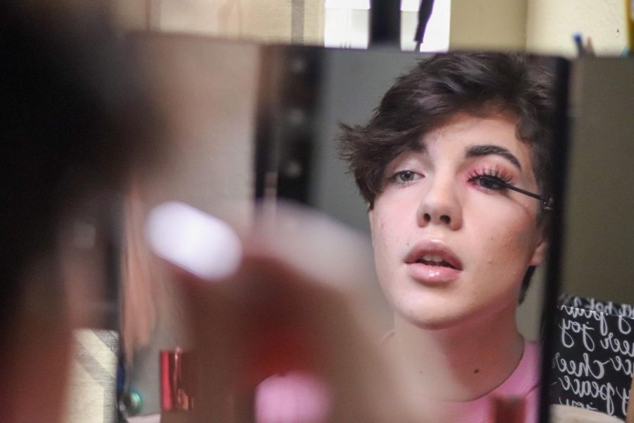 Coppell High School sophomore Michael Creed adds the finishing touches to his makeup with mascara and fake eyelashes in his bedroom mirror on Jan. 11.  Creed uses makeup as an artistic tool to push gender boundaries.