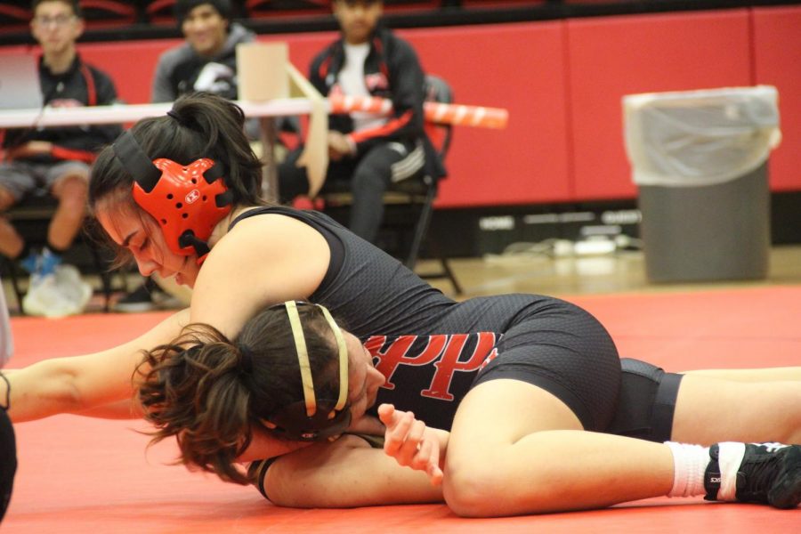 Coppell junior Dorian Villalba tackles senior Huitron Genesis from Keller Fossil Ridge in her victorious 138 pound weight class match on Jan. 31 in the CHS Arena for Senior Night. The boys and girls wrestling teams competed in the UIL District 6-6A Championships at Prosper High School on Thursday.