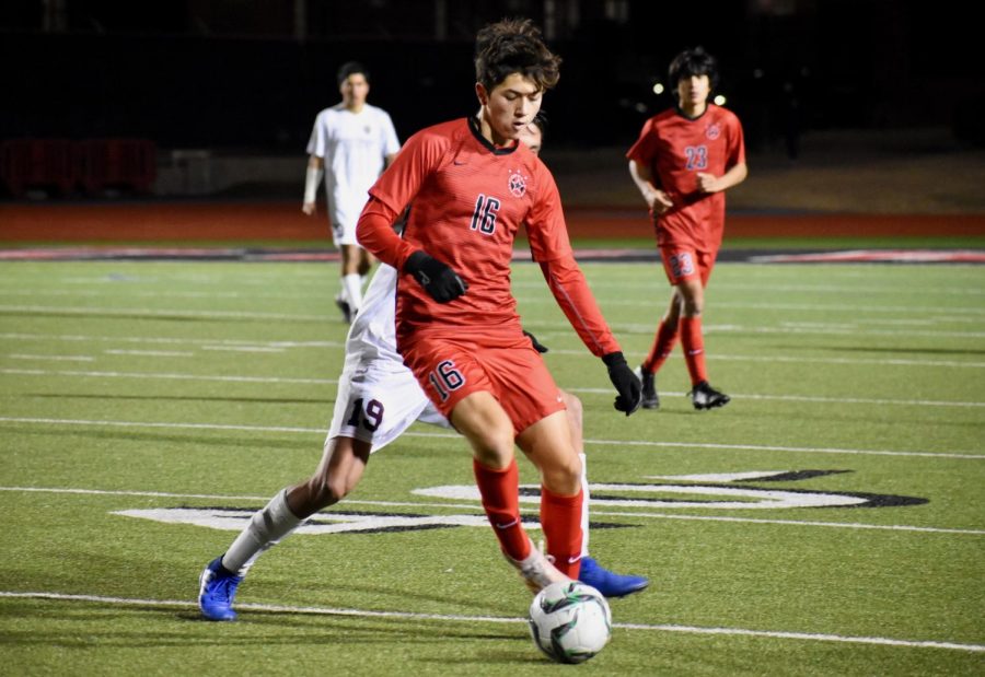 Coppell freshman forward Preston Taylor blocks his opponent during the scrimmage against Frisco Heritage on Dec. 17 at Buddy Echols Field. The Cowboys ended the game with a score of 1-1.