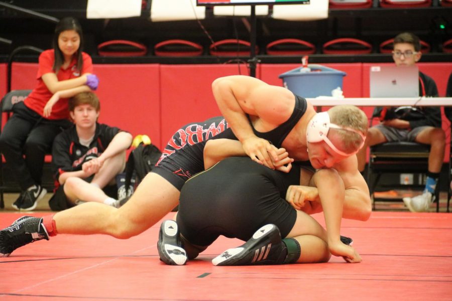 Coppell senior team captain Jackson Briscoe turns Fossil Ridge junior Allen Churchwell in his victorious  170 weight class match. Coppell competed against Keller Fossil Ridge yesterday in the CHS Arena.