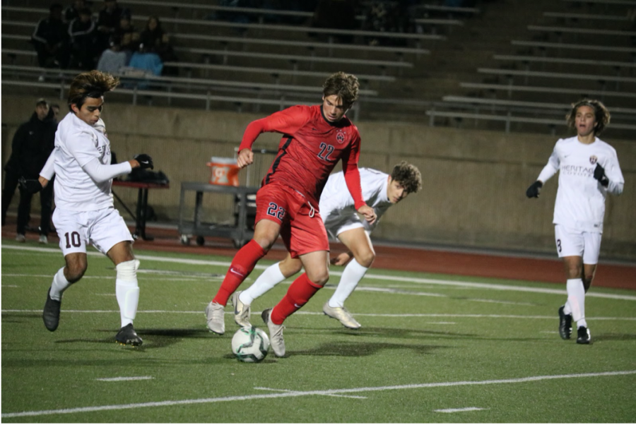 Coppell+senior+midfielder+Sebastian+Blaas+shields+against+Frisco+Heritage+defenders+during+the+scrimmage+on+Dec.+17+at+Buddy+Echols+Field.+Blaas%E2%80%99s+club+soccer+team%2C+Solar+02B%2C+won+the+U.S.+National+Youth+Soccer+Championship+nationals+during+the+summer.