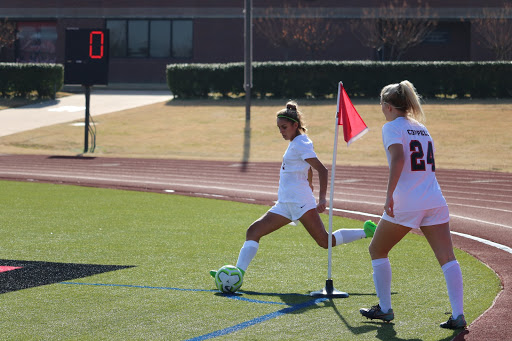 Coppell junior forward Jocelyn Alonzo takes a corner kick against Little Elm on Dec. 14 on Buddy Echols Field. The Cowgirls begin District 6-6A play against Irving Macarthur tomorrow at Buddy Echols Field at 7:30 p.m.