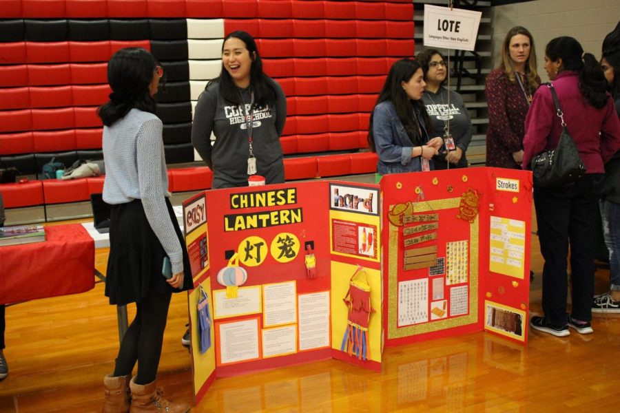 Languages Other Than English (LOTE) teachers display triboards about the Chinese culture in the Coppell High School main gym on Tuesday. Teachers were stationed throughout the gym, cafeteria and commons for the spring showcase, which gave incoming students the opportunity to inquire about courses for the 2020-2021 school year.