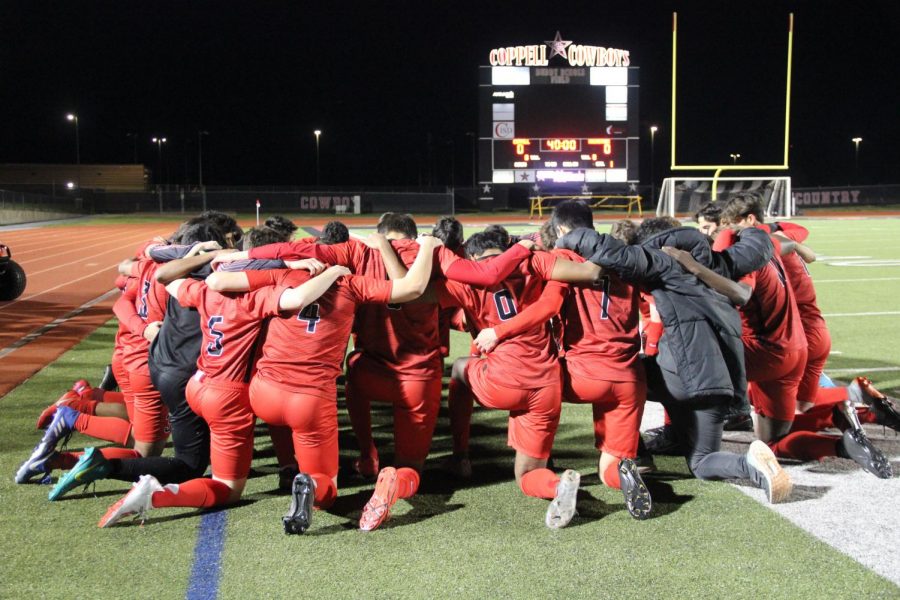 The Coppell soccer team huddles at Buddy Echols Field on Friday against MacArthur. Cowboys defeated the Cardinals, 2-1. 