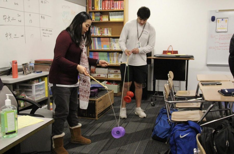 Coppell High School Mandarin Chinese teacher Andrea Voelker instructs junior Shoy Border how to play Chinese yoyo during third period on Jan. 23.