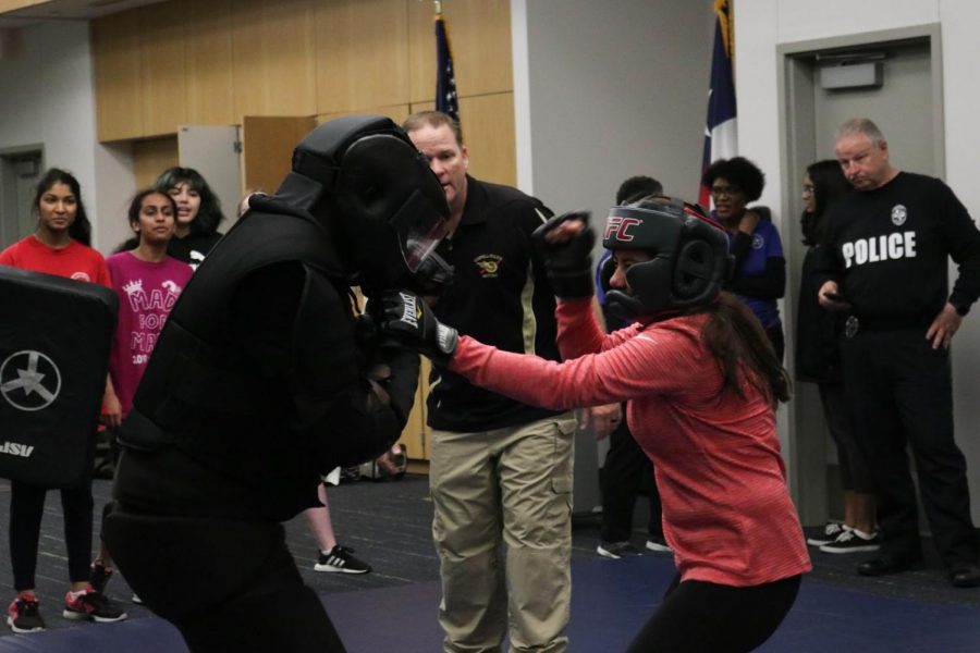 Coppell+High+School+senior+Michelle+Moller+presents+her+one-on-one+fight+practice+test+against+Officer+Tonard+Warmsley+during+self-defense+class+on+Feb.+18.+The+class+is+every+Tuesday+from+6-8+p.m.+at+the+Coppell+Police+Department.+