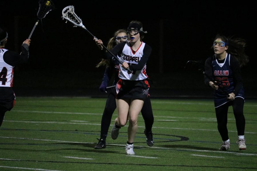 Coppell High School junior midfielder Ella Jenkins passes against Allen on Thursday night at Coppell Middle School North. The Cowgirls lost to the Eagles, 10-3.