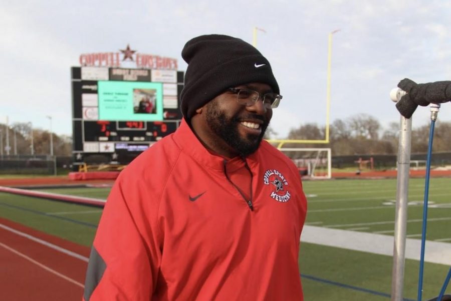 Coppell+High+School+and+CHS9+athletic+trainer+and+sports+medicine+instructor+Brian+Terrell+carries+equipment+to+a+cart+at+Buddy+Echols+Field+on+Tuesday.+Terrell+is+a+trainer+at+CHS+and+CHS9+and+enjoys+helping+athletes+face+and+overcome+their+challenges.+Photo+by+Camila+Flores