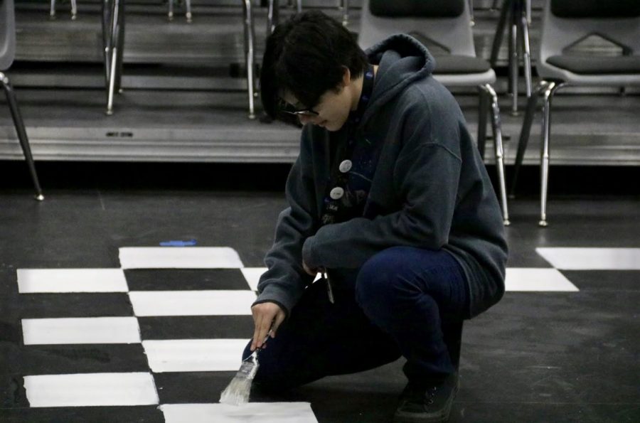 Coppell High School sophomore Nico Cabrera paints the floor of the Black Box Theatre on Thursday. CHS Theater Department‘s “12 Angry Jurors” show performs tomorrow night, Saturday night and Sunday night in the CHS Black Box Theater.