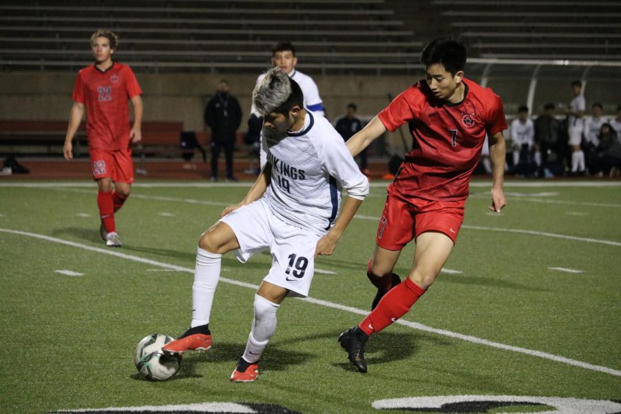 Irving Nimitz’s Jonathan Morales dribbles away from Coppell senior midfielder Ben Wang last night at Buddy Echols Field. Nimitz came back from a two-goal deficit to defeat the Cowboys, 3-2.