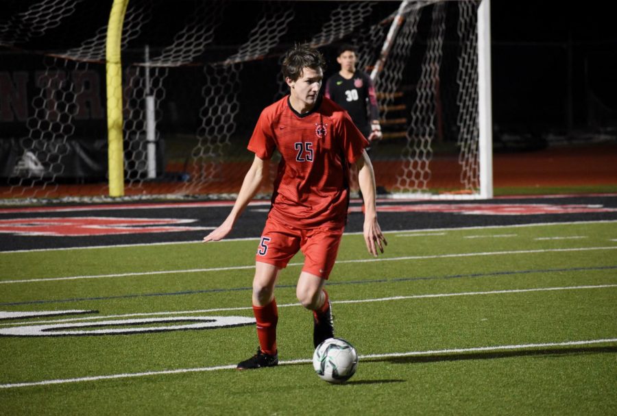 Coppell junior defender Collin MacDonald looks for teammate against Irving on Friday at Buddy Echols Field. The Cowboys lost, 2-1, to the Tigers and play at Flower Mound on Tuesday.