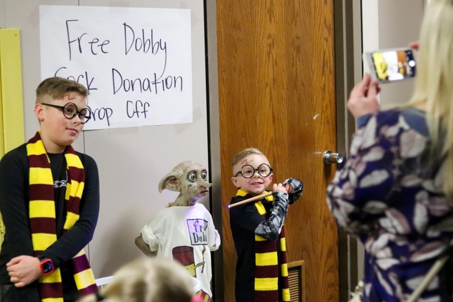 Pinkerton Elementary School students pose for a picture in the hallway next to a Harry Potter themed sock donation at Pinkerton’s Harry Potter Night on Feb. 20. The event featured various activities such as Hogwarts house sorting, a Horcrux scavenger hunt, photo booth and a movie showing of Harry Potter and the Chamber of Secrets.