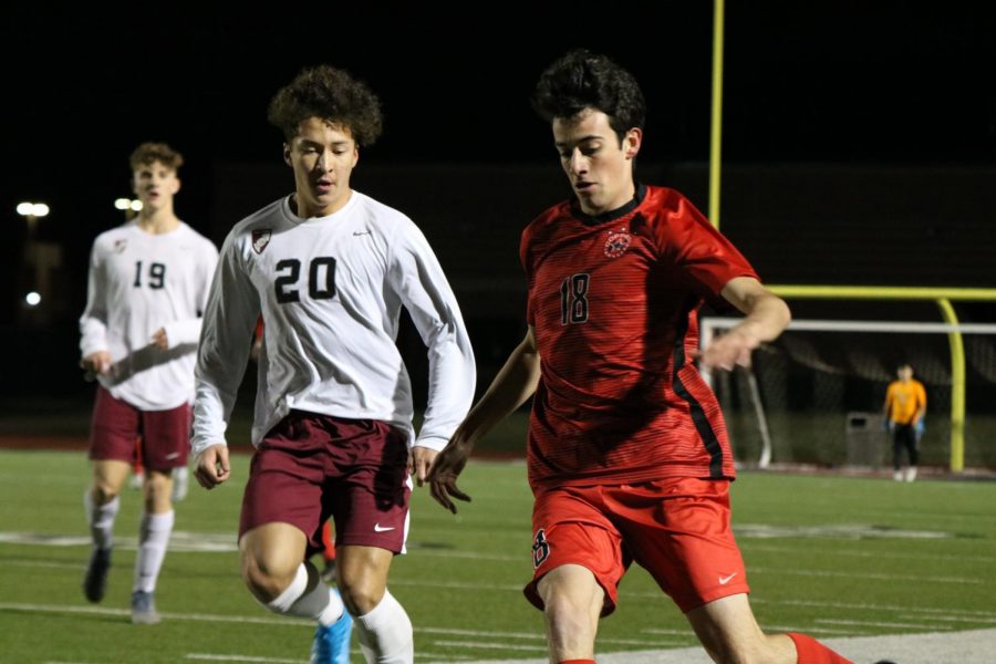 Lewisville senior midfielder Chris Guerrero and Coppell junior right back Daniel Nelson fight for possession on Friday at Buddy Echols Field. The Cowboys ended the night with a scoreless tie in their second home District 6-6A match of the season.