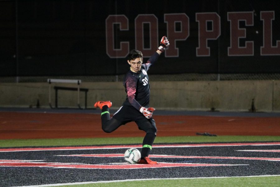 Coppell sophomore goalkeeper Arath Valdez takes a goal kick against Lewisville last night at Buddy Echols Field. The Cowboys ended the night with a scoreless tie in their second home District 6-6A match of the season.  