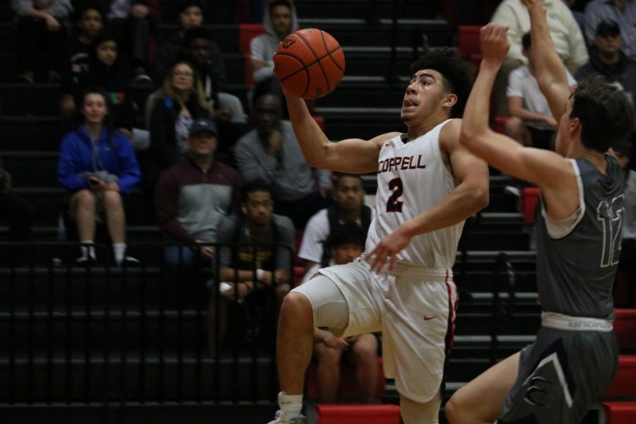 Coppell senior guard Brandon Taylor goes for a layup against Eaton on Tuesday at Trinity High School in Euless. The Cowboys defeated Eaton, 80-46, in Class 6A Region I bi-district playoffs.