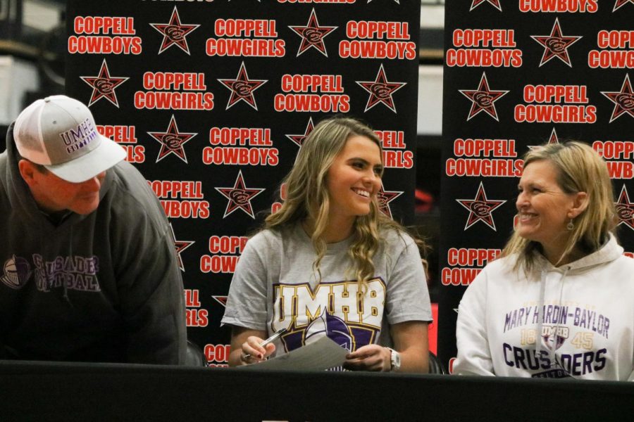 Coppell senior center fielder Rylee Anderson grins to her parents, Aric and Lynette Anderson, after signing to the University of Mary Hardin-Baylor for softball in the CHS Arena on Wednesday. Signing Day saw six Coppell athletes commit to four colleges for the respective sports. 
